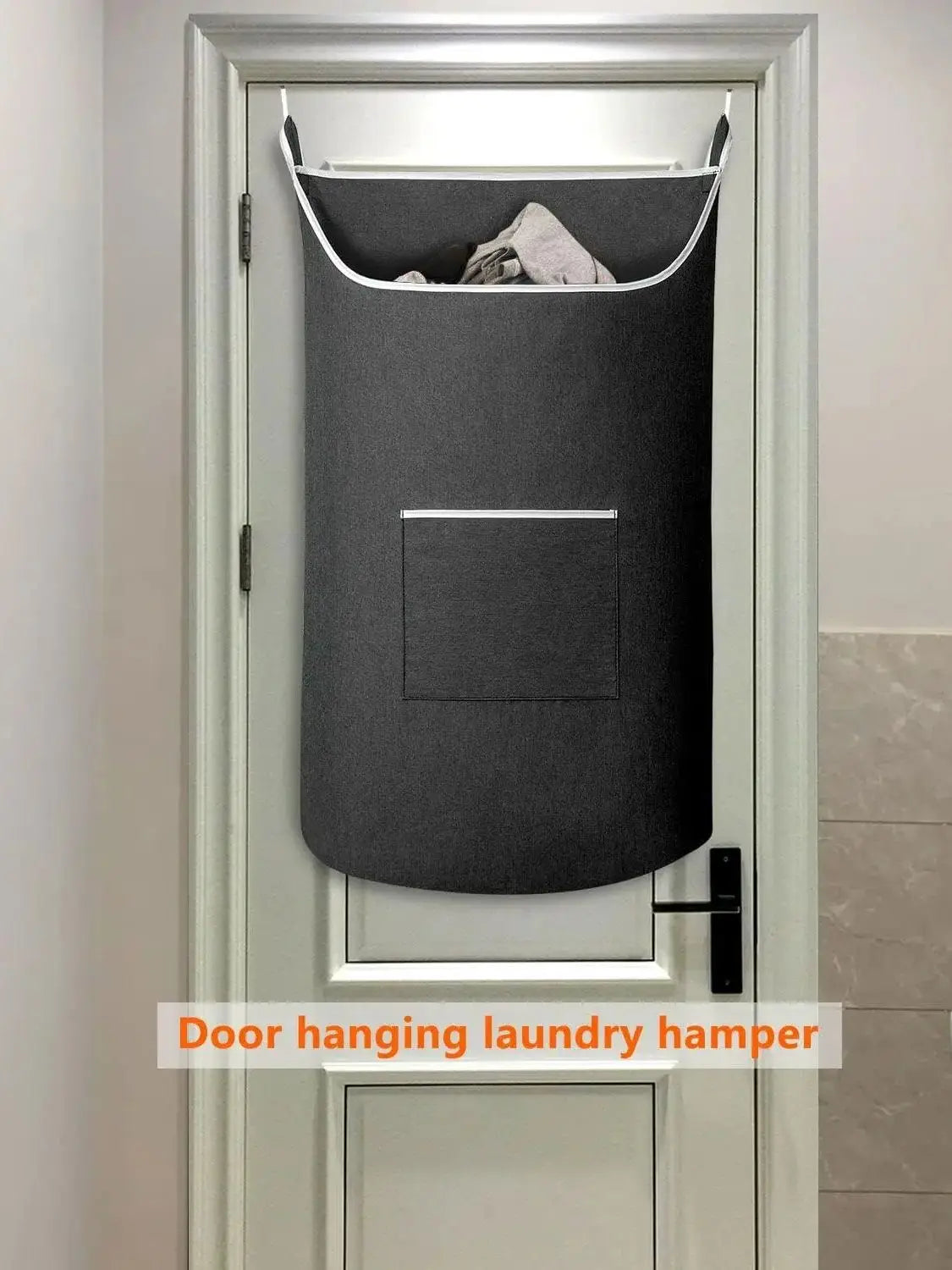 A gray hanging laundry hamper is mounted on a white door with a rectangular window.