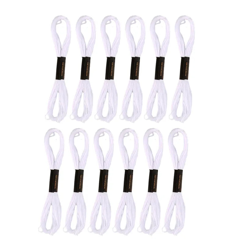 A set of 24 embroidery floss spools in white and black.