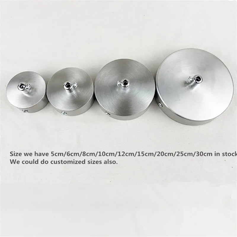A row of polished stainless steel ceiling mount canopy discs of various sizes are displayed.