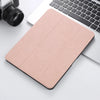 A light pink retro marble case for an iPad Pro 12.9 with a built-in pencil holder, placed next to a laptop and camera.