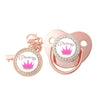 A rose gold crystal rhinestone pacifier chain clip set with silicone nipple and crown charm.