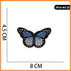 A butterfly embroidered iron-on patch featuring blue and white wings.