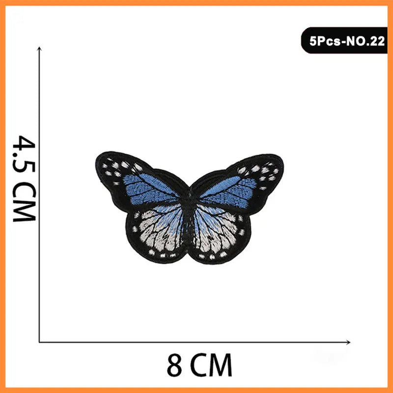 A butterfly embroidered iron-on patch featuring blue and white wings.
