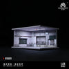 A 1:64 scale miniature garage diorama kit featuring a lighted interior display.