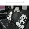 Black car seat covers with white panda headrest pillows installed in a vehicle interior.