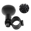 A black universal steering wheel spinner knob and a pile of black plastic knobs for driving aids.