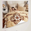 A double-sided blanket featuring a beige floral pattern is shown draped over a bed, highlighting its soft texture.