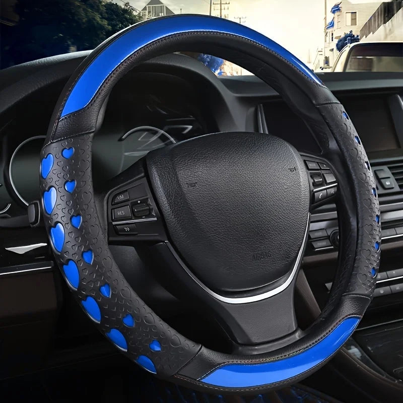 A black steering wheel with blue heart-shaped leather covers and stitching inside a car interior.