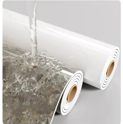 A roll of self-adhesive marble wallpaper being applied to a surface.
