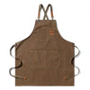 A brown cotton canvas apron with cross-back straps and multiple pockets.