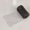 A roll of black PVC-coated hexagonal garden fencing netting laid out on a white surface.