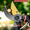 A pair of precision pruning shears with a gold-colored blade and black handle are shown being held by a hand.