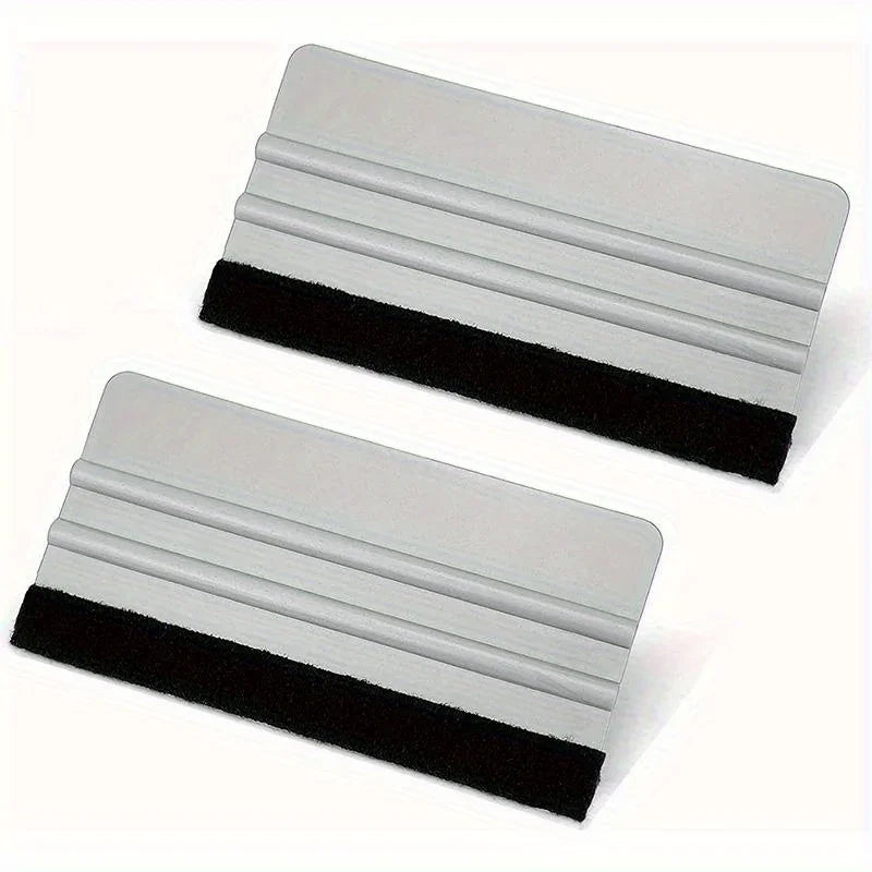 A silver scratch-free vinyl applicator tool with black grip, shown from the side.