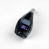 A close-up view of a black crystal gear shift knob with purple LED illumination and a silver cap.