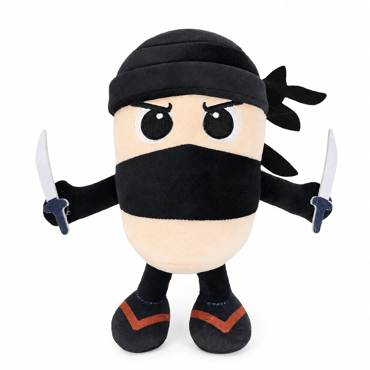 A black and tan plush toy of a shark character with a mask and small blades.