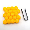 A yellow, honeycomb-shaped set of 20 plastic caps designed to cover car wheel nut bolt holes.