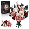 A bouquet of pink and cream roses and greenery displayed next to its packaging box.