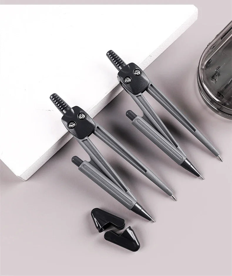 A set of eight drafting tools including compasses and rulers displayed on a white surface.