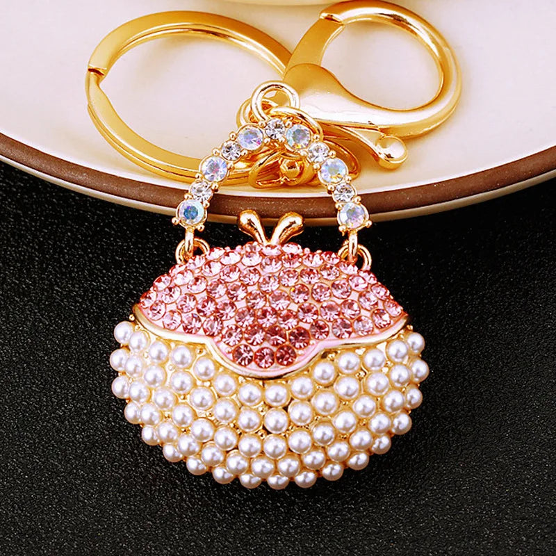 Gold and pearl crystal rhinestone handbag keychain with a pink floral charm