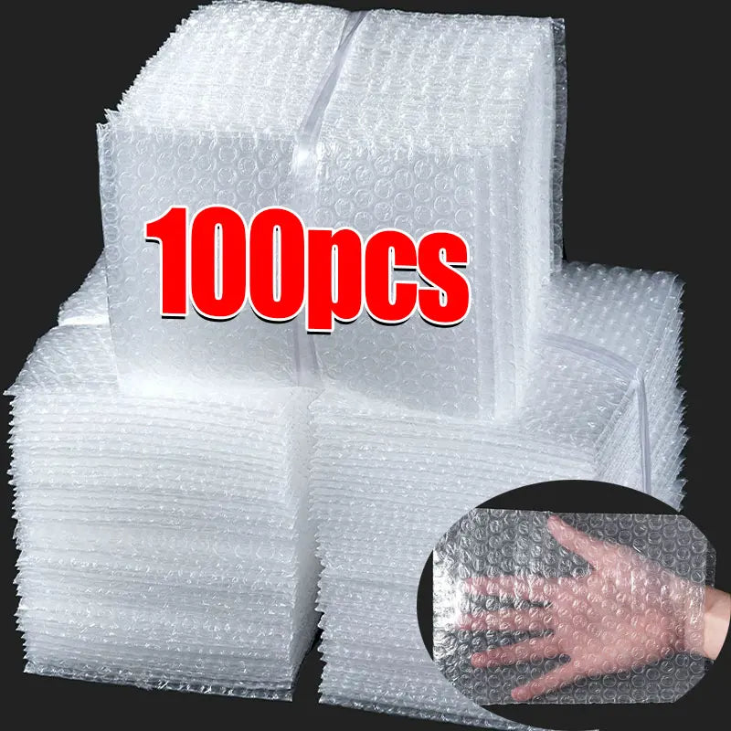 A stack of clear bubble mailers showing 100 pieces, with a hand demonstrating the cushioning protection.