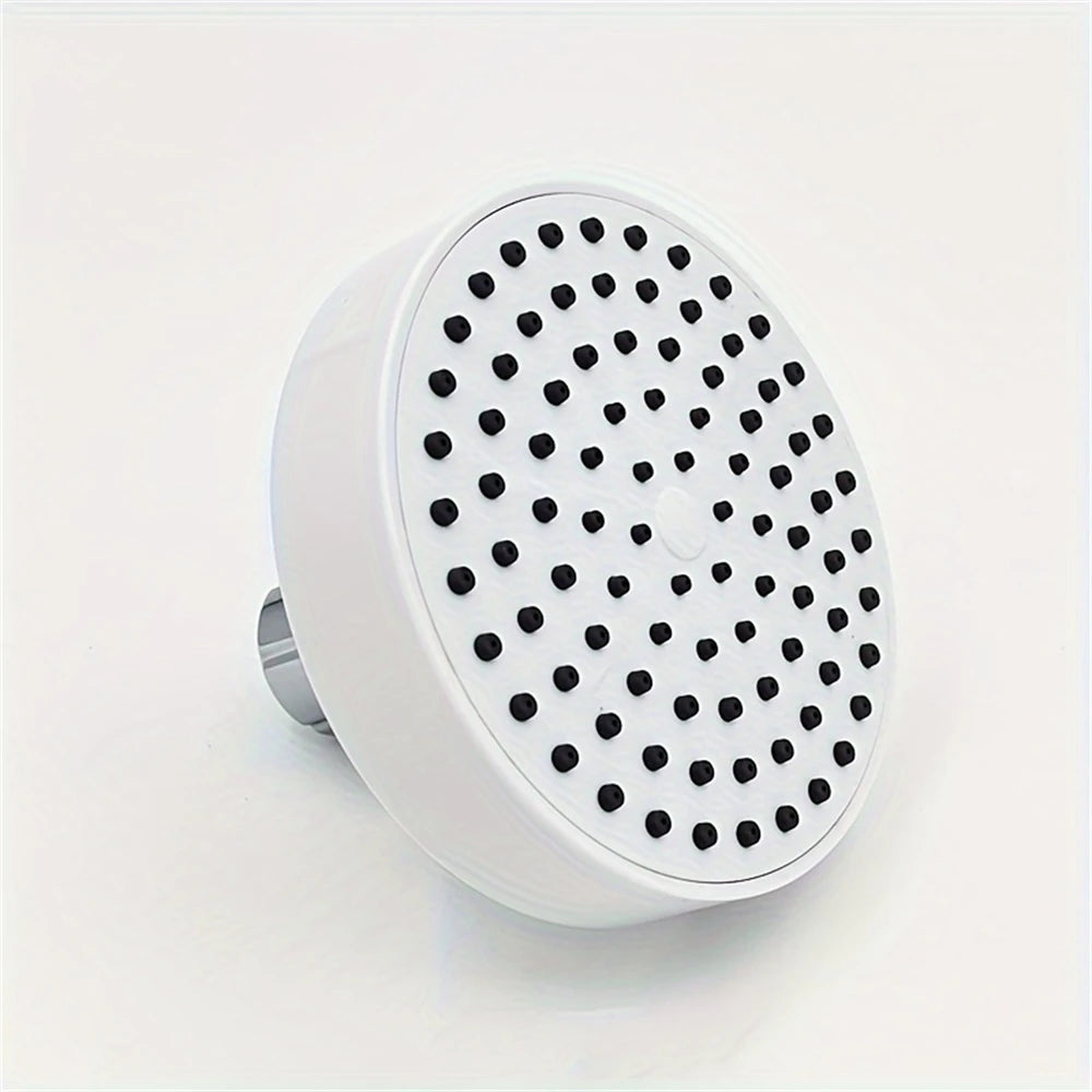 A white shower head with a perforated disk is shown against a white background.
