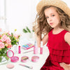 A young girl models a 10-piece Pretend Play Makeup Set for Kids toy cosmetics kit with various pink and purple makeup product