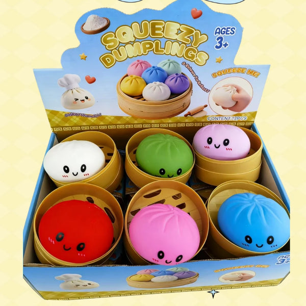 A box of Squeezzy Dumplings toys in various colors including yellow, purple, pink, and blue.