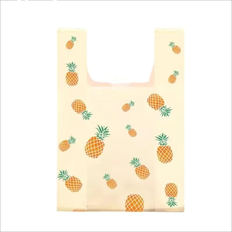 A set of mini fruit-print tote bags with handles featuring various citrus fruits.