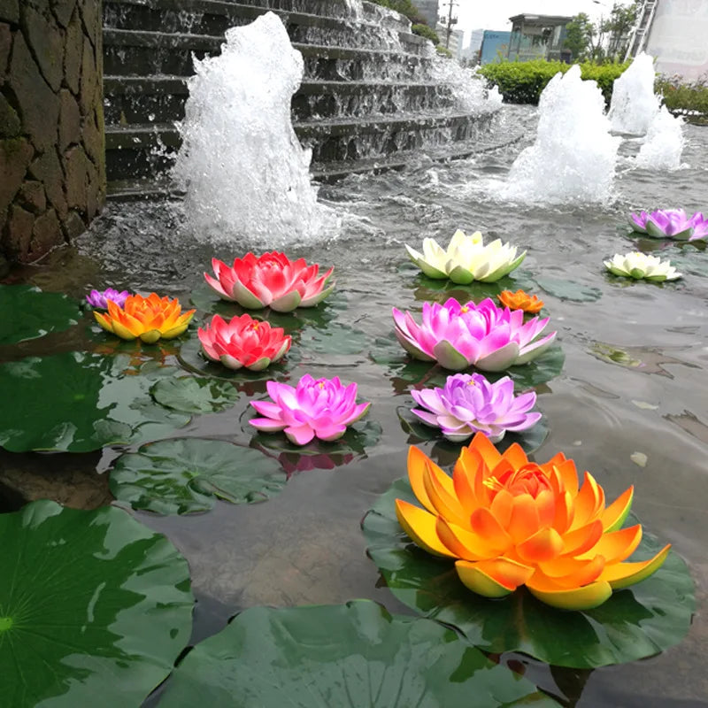 Pink and orange lotus flowers floating on water with a stone waterfall background