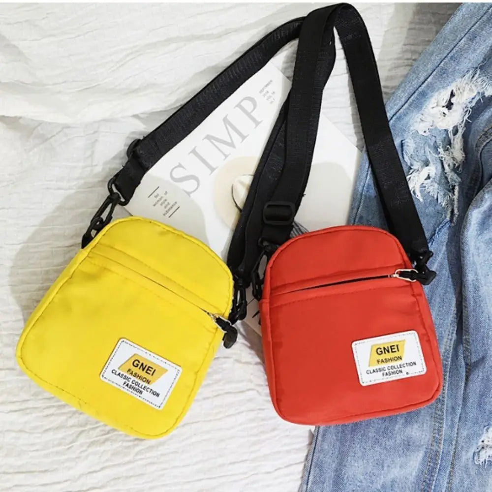 A yellow mini canvas crossbody bag and a red mini canvas crossbody bag are shown against a white background.