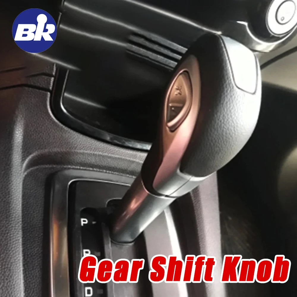 Close-up view of a leather-wrapped gear shift knob inside a vehicle cabin.