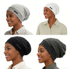 A collection of silk-like night caps in gray and black shown on models.