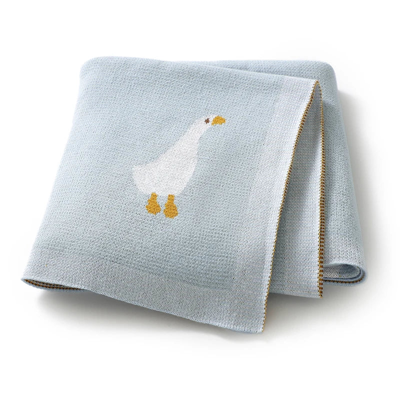 Light blue soft cotton baby swaddle blanket featuring a white cartoon duck print.