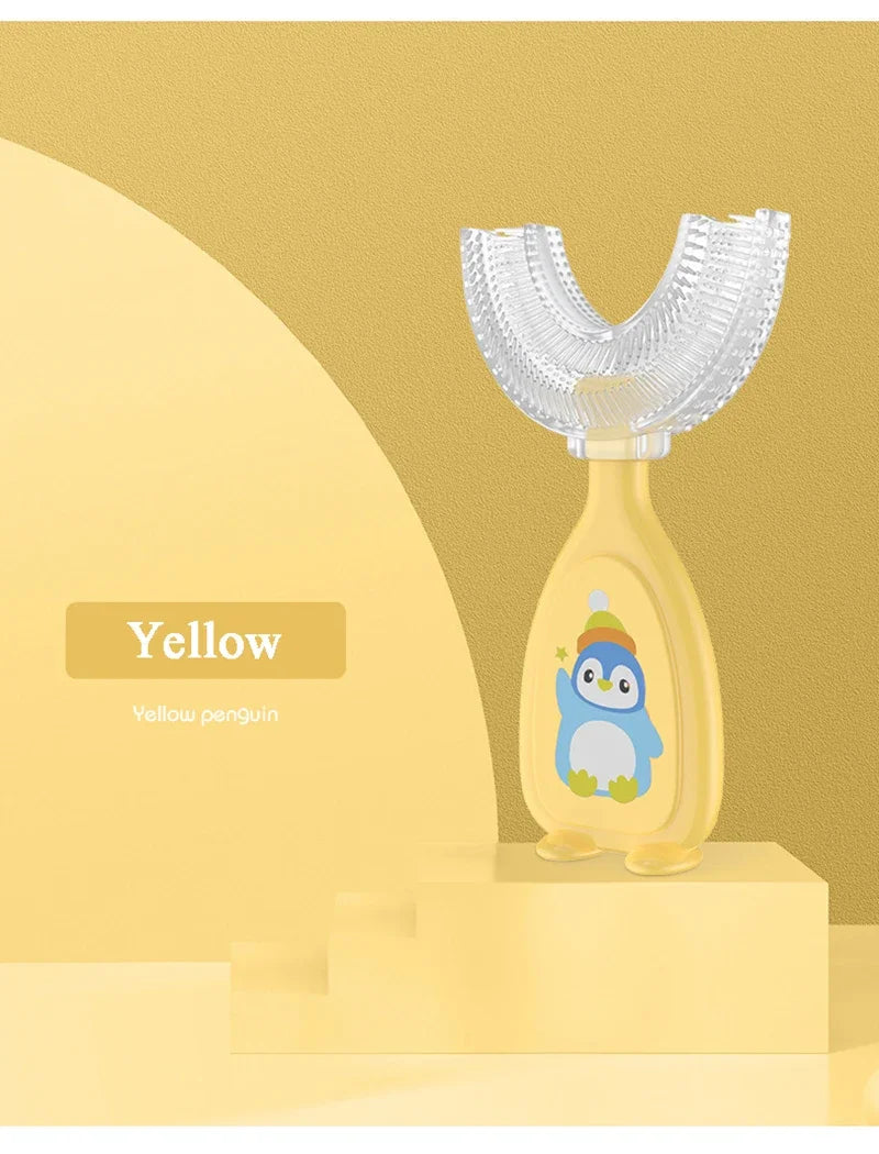 Yellow penguin shaped U-shaped silicone toothbrush for kids displayed on a stand.