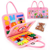 A pink Montessori busy board for toddlers featuring various colorful manipulative items and learning tools.