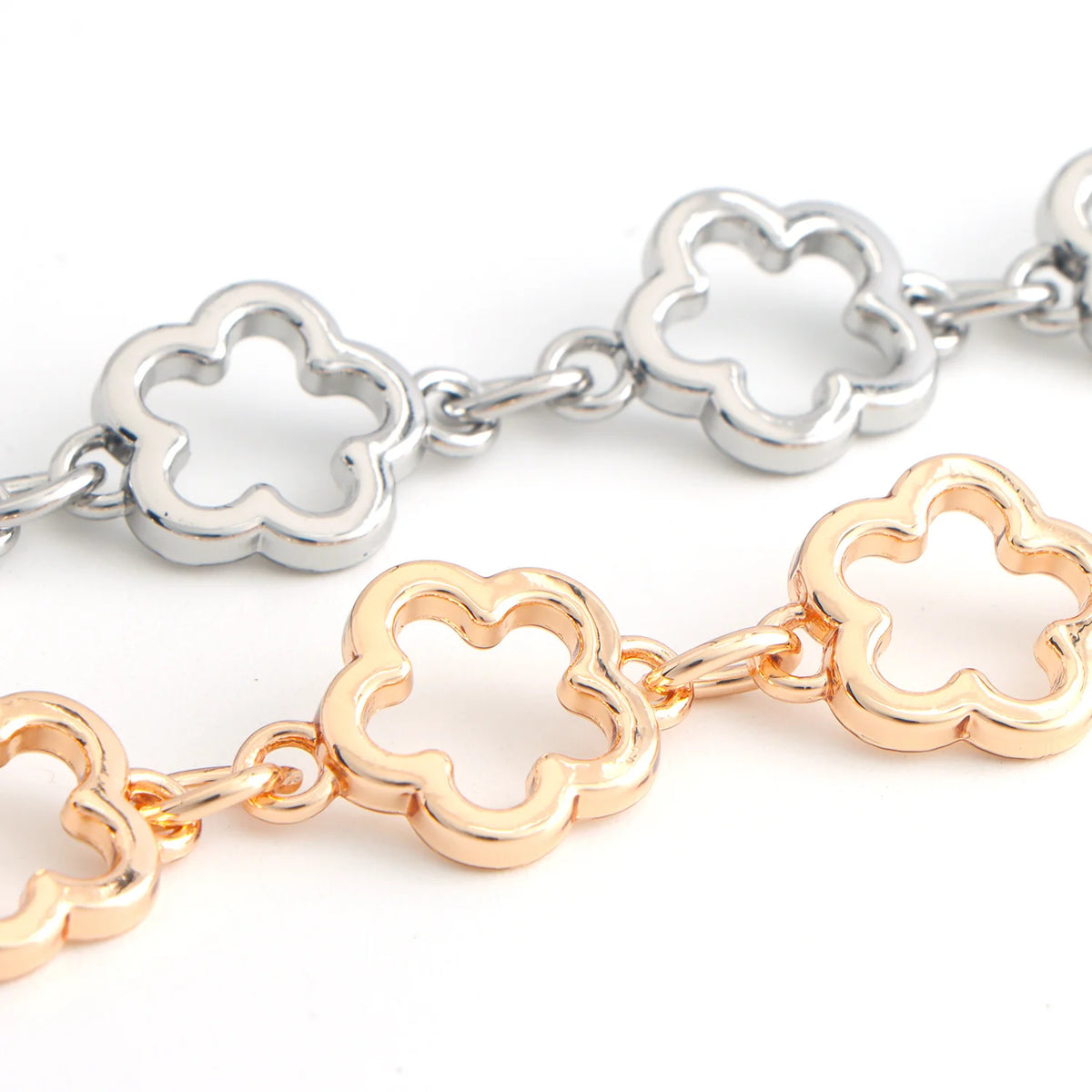A pair of adjustable flower bag chains, one silver and one gold, displayed against a white background.