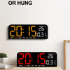 A black LED digital wall clock displaying the time 20:15, temperature 26°C, and day of the week.