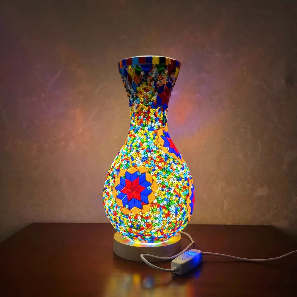 A handcrafted Turkish mosaic table lamp with a vibrant, colorful glass base and warm LED glow.
