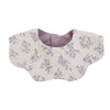 A light beige muslin cotton baby bib with a purple floral print and a gray snap closure.