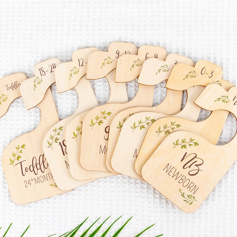 A set of wooden baby closet dividers used as size organizers for newborn to 24 months.