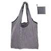A black and white striped reusable nylon shopping tote bag shown in a vertical orientation.