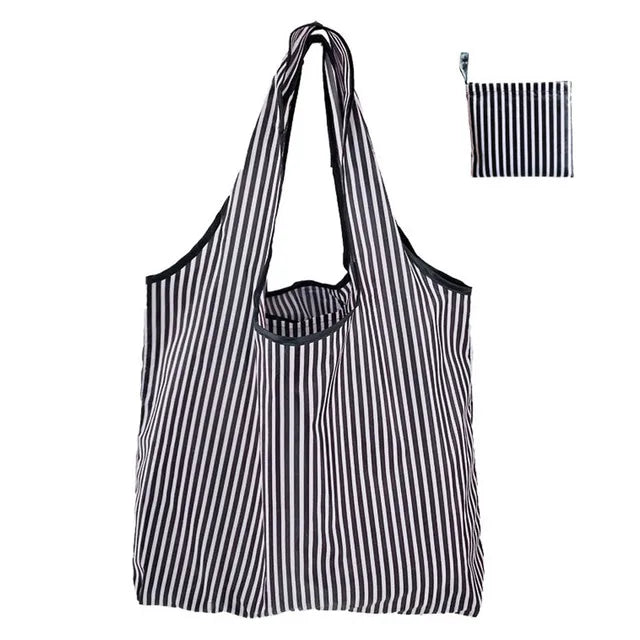 A black and white striped reusable nylon shopping tote bag shown in a vertical orientation.