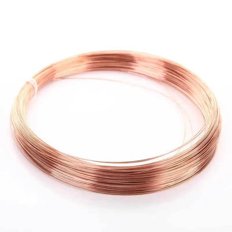 A coil of rose gold enameled copper wire used for jewelry making and electrical projects.