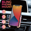 A pink crystal air vent car phone mount is shown installed in a car's interior dashboard.