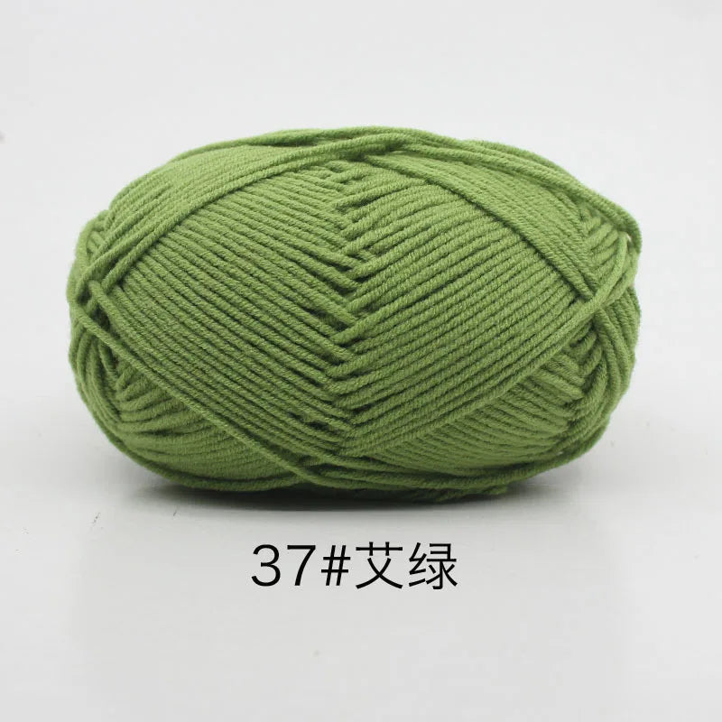 A ball of soft 4-ply milk cotton yarn in a moss green color.