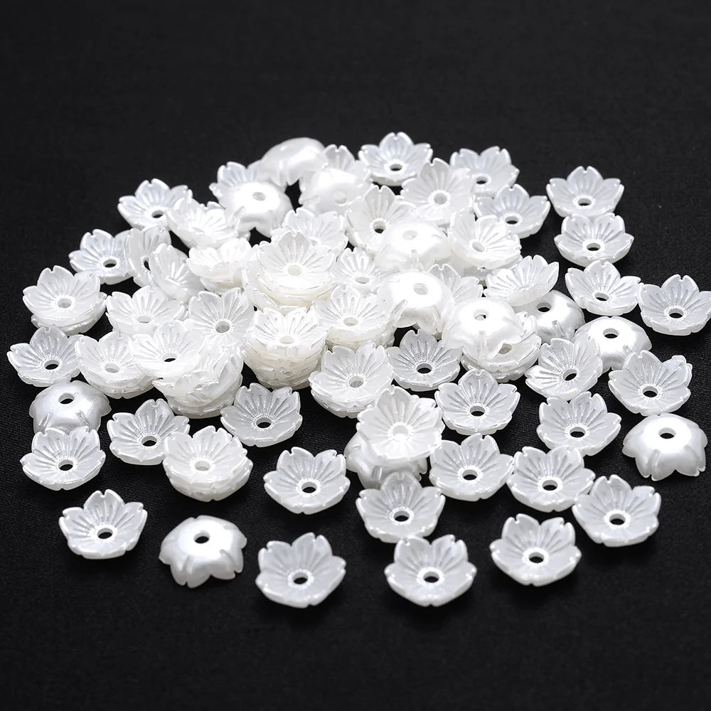 A pile of 100 white acrylic pearl spacer beads for jewelry making