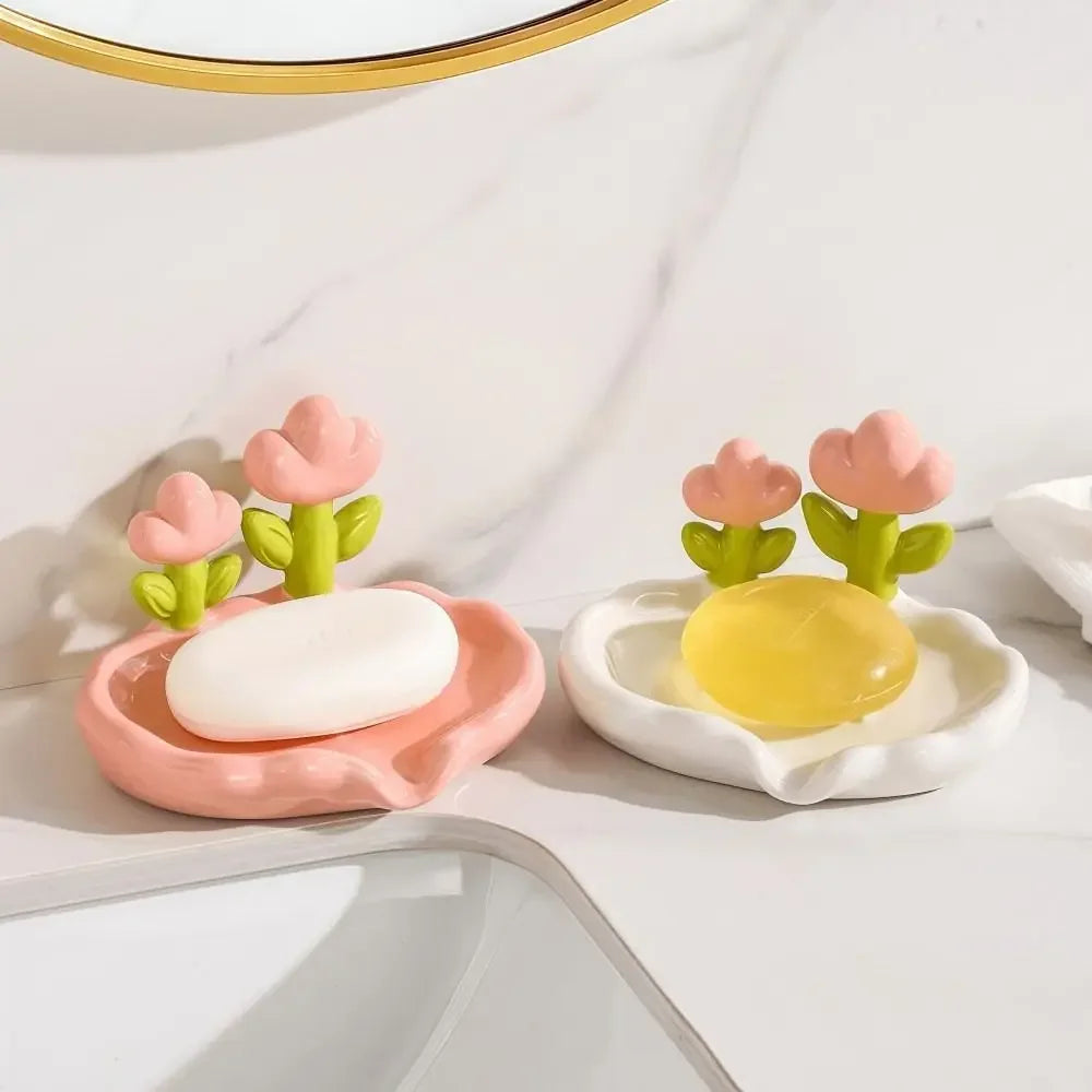 A set of pink and white ceramic soap dishes featuring tulip-shaped soap and drainage trays.