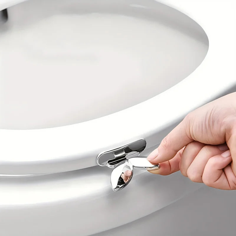 A hand is lifting the toilet seat using a flush button mechanism on a white toilet.