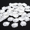 A pile of 100 white acrylic pearl spacer beads for jewelry making.