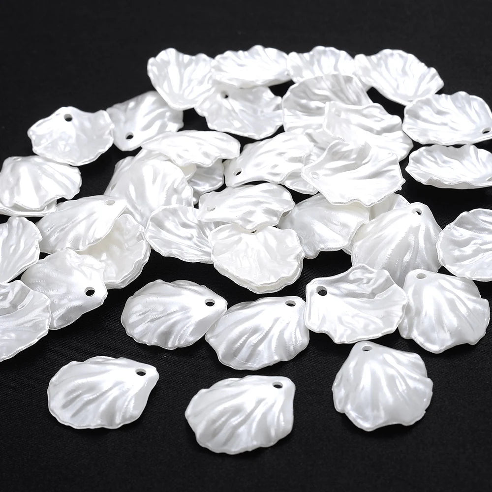 A pile of 100 white acrylic pearl spacer beads for jewelry making.